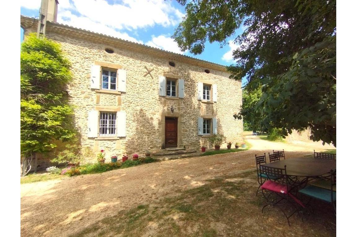 Entrée du gîte et salon de jardin à l'ombre de l'arbre